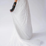 Flowing train of Dauphine Lace Gown in motion, emphasizing the gown's ethereal lace and lightweight bridal design.