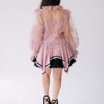 Sheer pink lace blouse with long puff sleeves shown from behind.