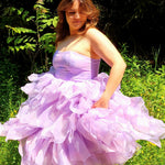 Lavender Eventyr Tulip Dress with voluminous, ruffled skirt, hand cut and hand dyed, worn by a woman in the forest for a fairytale look.