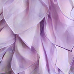 Delicate lavender flower petals highlight the hand cut and hand dyed Eventyr Tulip Dress