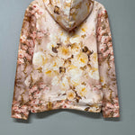 Back view of The Twilight Bloom Sleeper Hoodie on hanger, highlighting full floral print. Soft cotton hoodie perfect for floral fashion lovers.