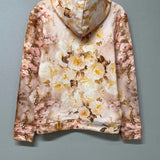 Back view of The Twilight Bloom Sleeper Hoodie on hanger, highlighting full floral print. Soft cotton hoodie perfect for floral fashion lovers.