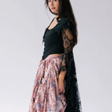 A black lace top with dramatic black lace billowing sleeves. Overtop a bustle maxi skirt.