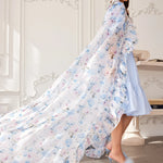 Flowing floral cloak crafted with over 10 yards of organza fabric in a light blue and pink delicate flower pattern.