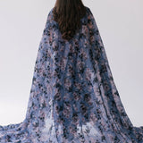 The High Priestess Victorian Cloak designed with a blue and purple floral print called Antique Floral and made entirely of Soft Poly Organza fabric.