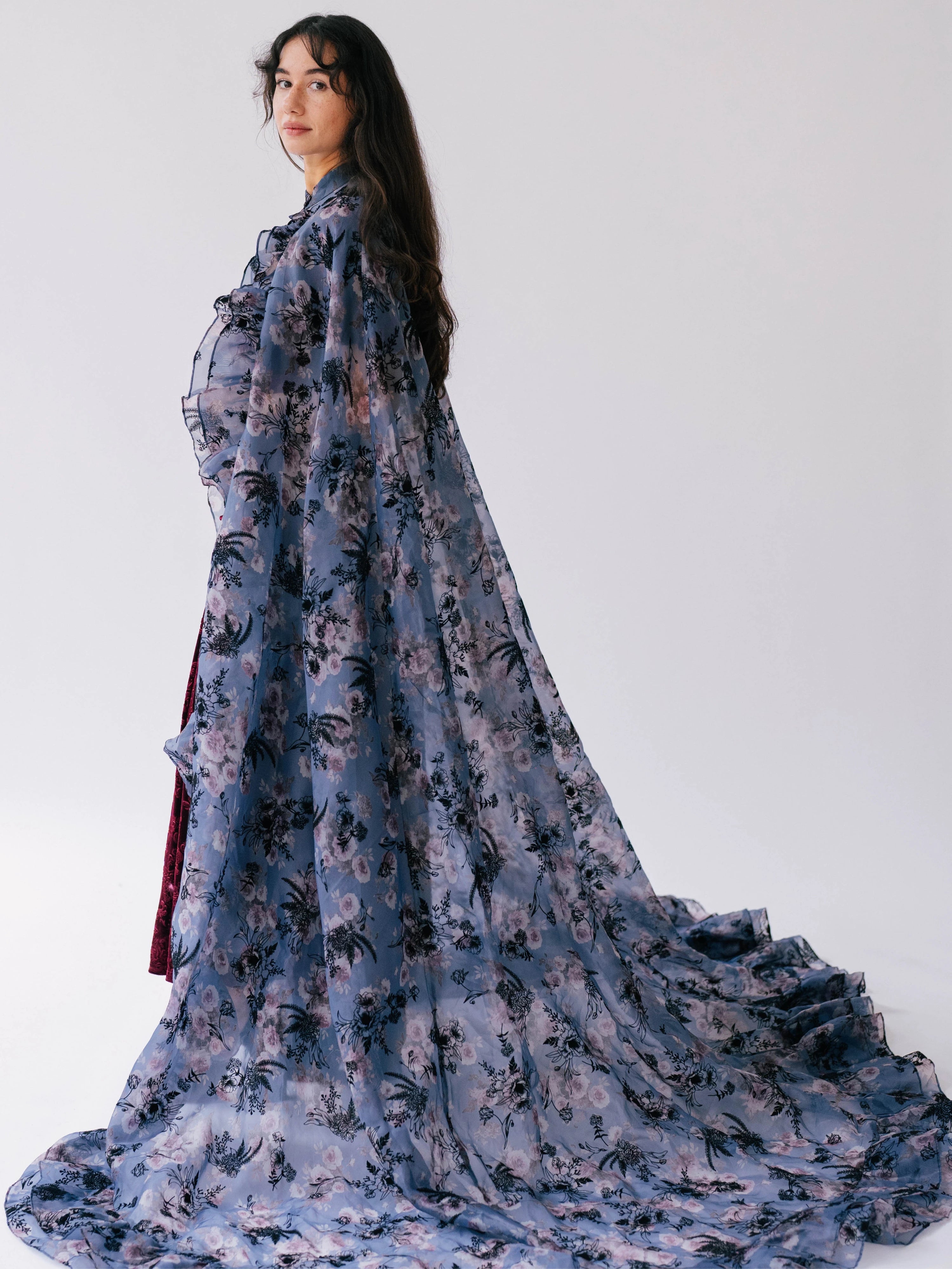 The High Priestess Victorian Cloak is an oversized flowing victorian purple poly organza cape with a light blue and pink floral print.