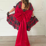 The Josephine Plaid Dress with a dramatic oversized red bow belt trailing to the floor.