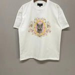 Flat lay of The Princess Kitten Tee on hanger, showing the full front design with pastel kitten artwork and floral details on white cotton.