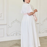 White swiss dot cotton ankle-length dress with short sleeves and a high neckline.