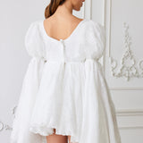 White puff-sleeve dress with a flared skirt and back zipper detail.