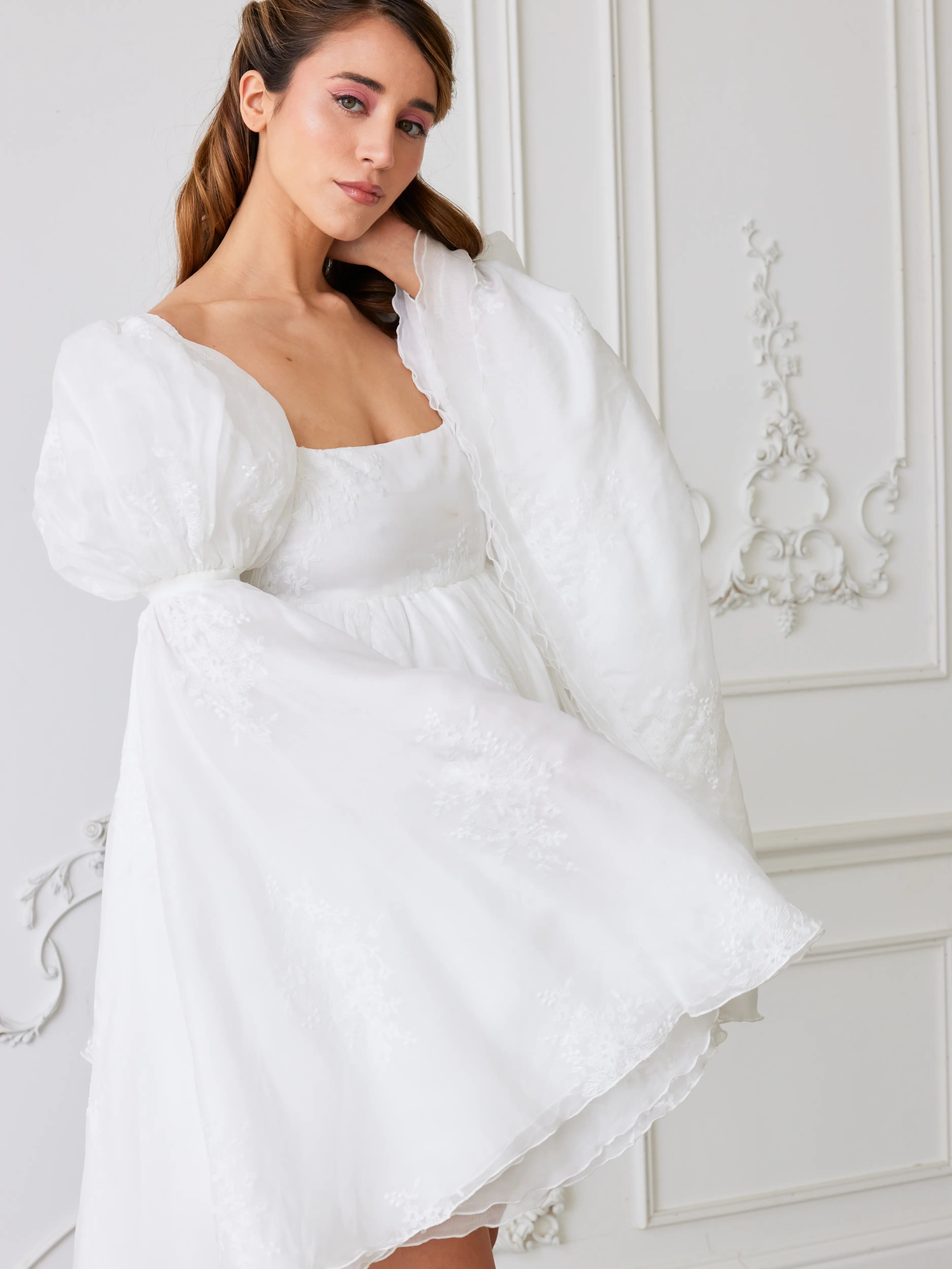 A white puff-sleeved mini dress with a square neckline.