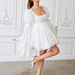 A white puff-sleeve mini dress with a full skirt and square neckline.