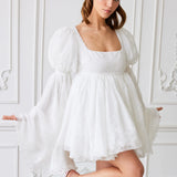 White puff-sleeve mini dress with a square neckline and flared skirt.