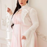 White bolero jacket over a light pink ruffled midi dress for a stylish Victorian look