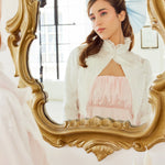 Ornate gold-framed baroque mirror reflecting The Ivory Lady Elizabeth Bolero Jacket and Alice Blue Grand Hair Bow.