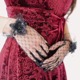 scarlet red brocade midi dress with black lace evening gloves featuring floral accents.