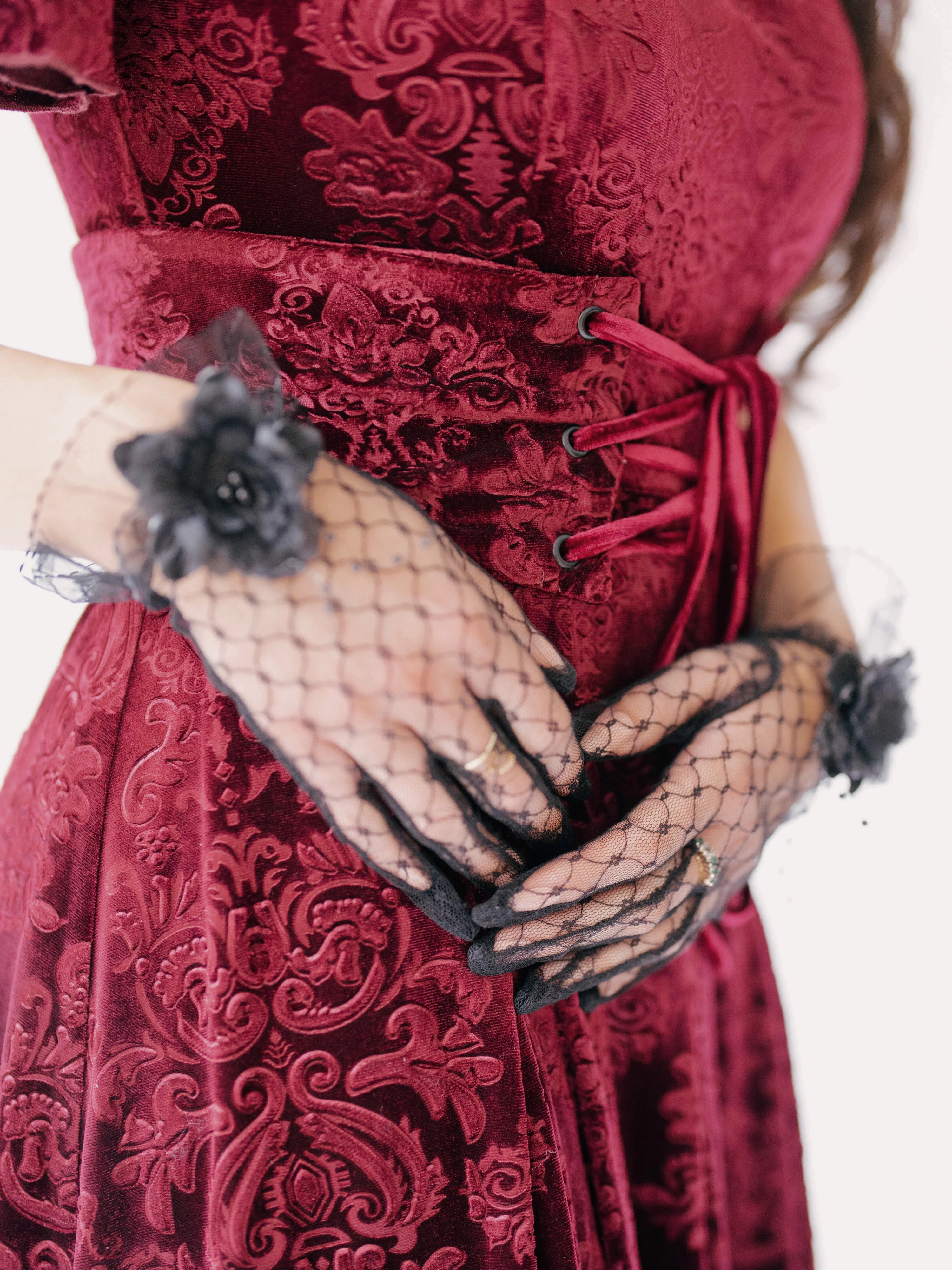 scarlet red brocade midi dress with black lace evening gloves featuring floral accents.