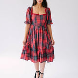 Red plaid midi dress with puff sleeves and tiered skirt.