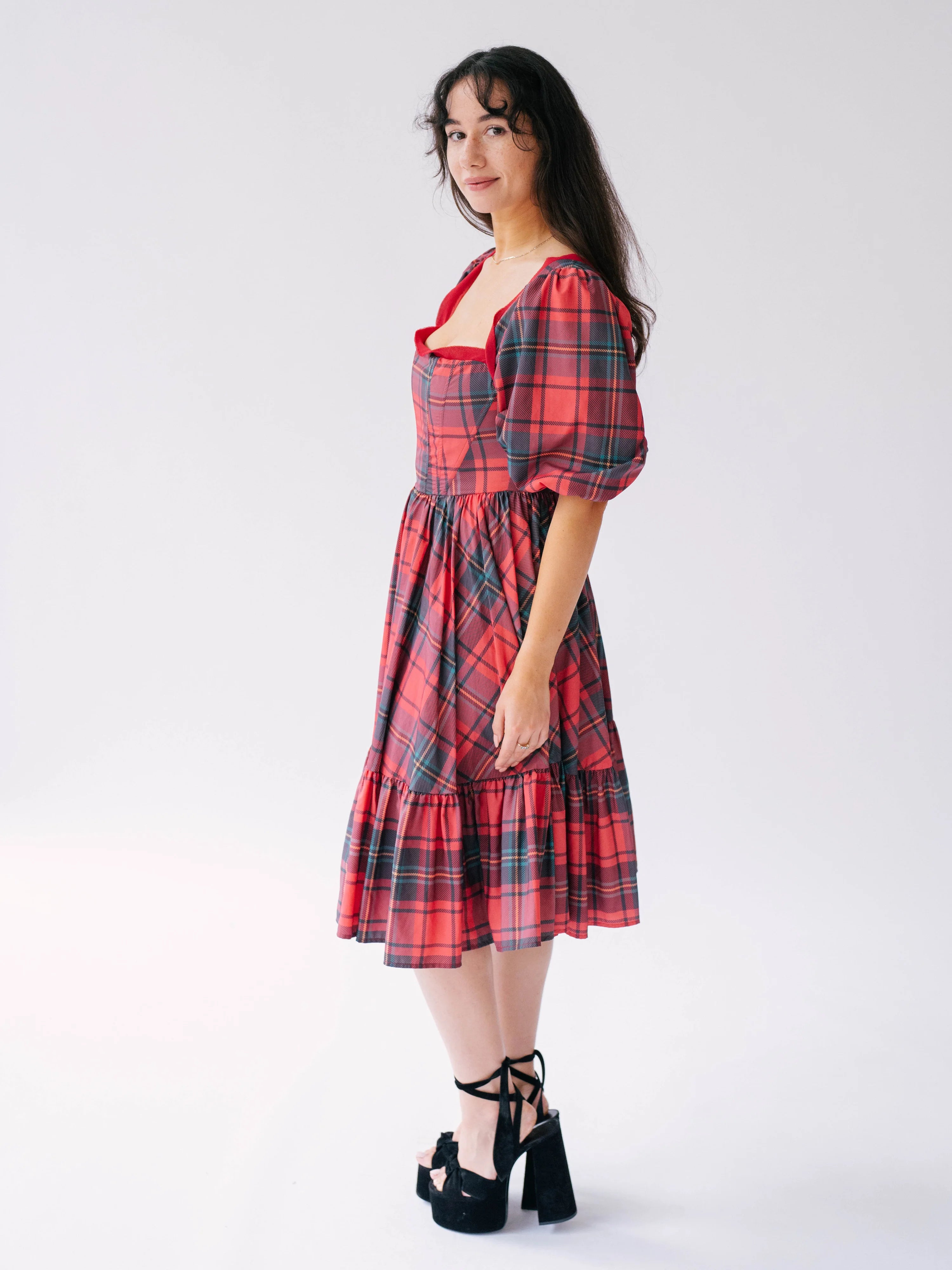 Red plaid holiday midi dress with puff sleeves and a tiered skirt.