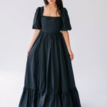 Black taffeta maxi dress with puff sleeves and a tiered ruffle hem.