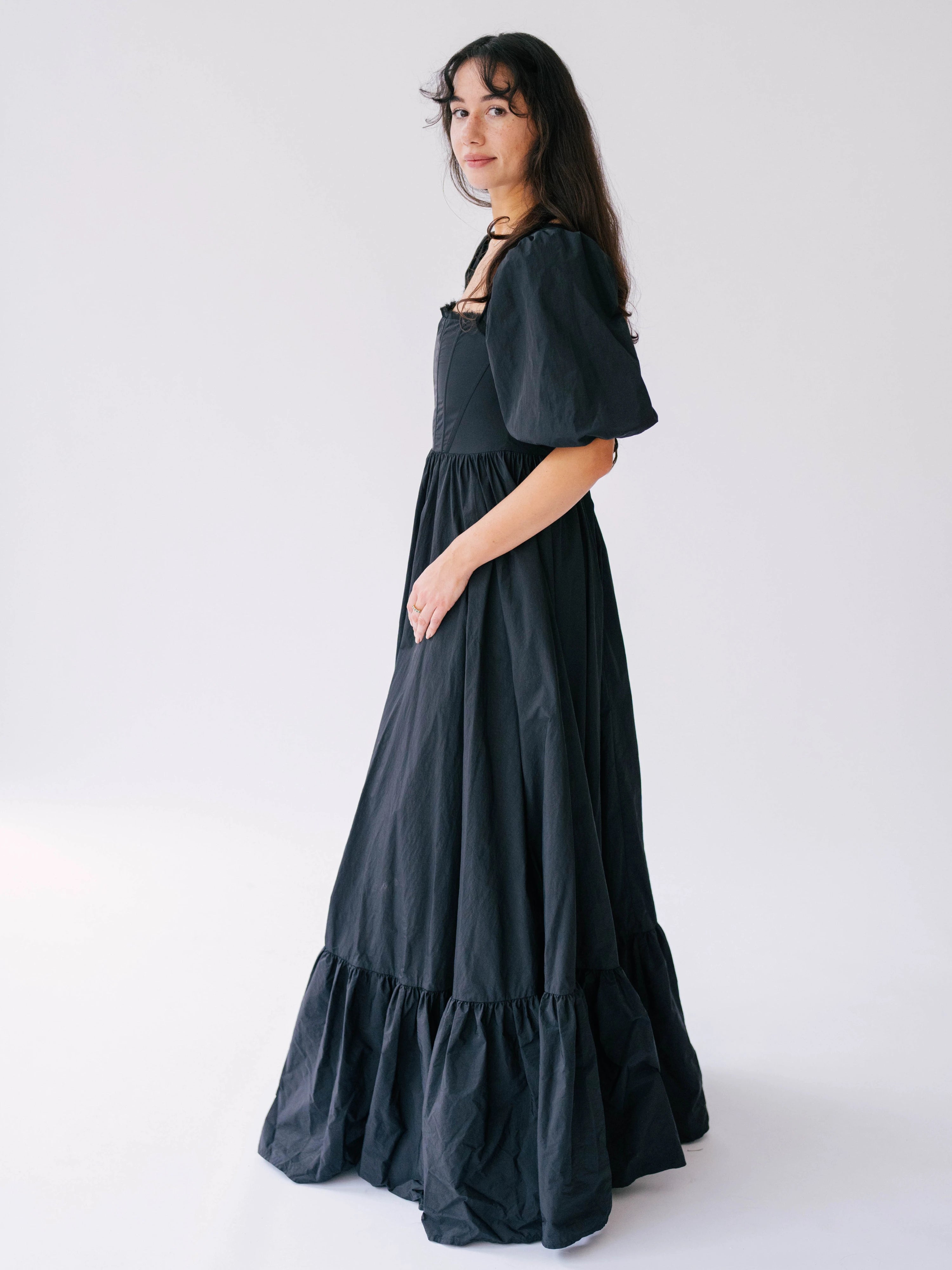 Black tiered victorian styled maxi dress with puff sleeves and corset boned bodice.