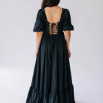 Black renaissance gown with puff sleeves and corset-style lacing on the back.