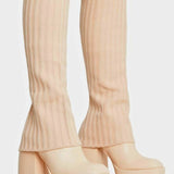 Cream-colored platform boots with ribbed sock-style uppers and chunky heels.