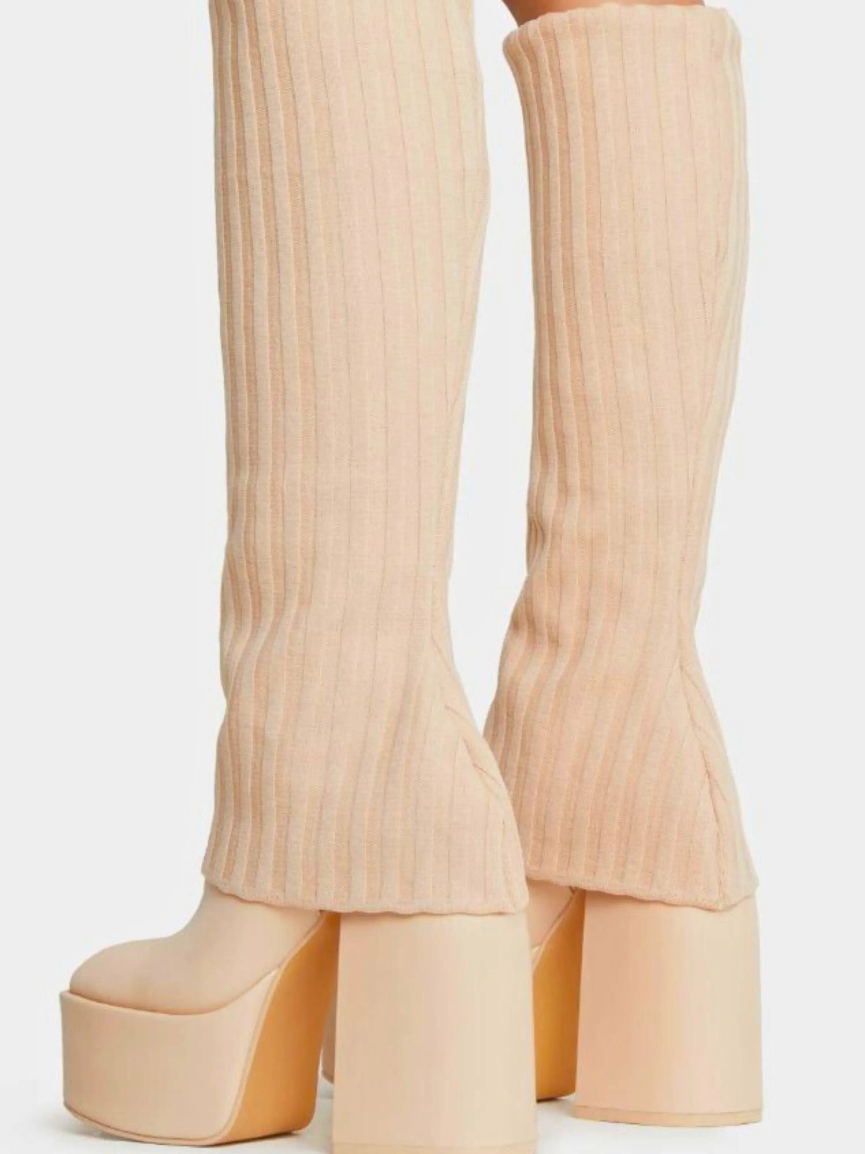 Cream-colored ribbed platform boots with chunky heels.