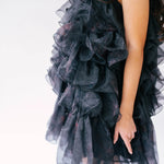 Black ruffled poly organza puff dress with layered tiers.