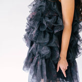 Black ruffled poly organza puff dress with layered tiers.