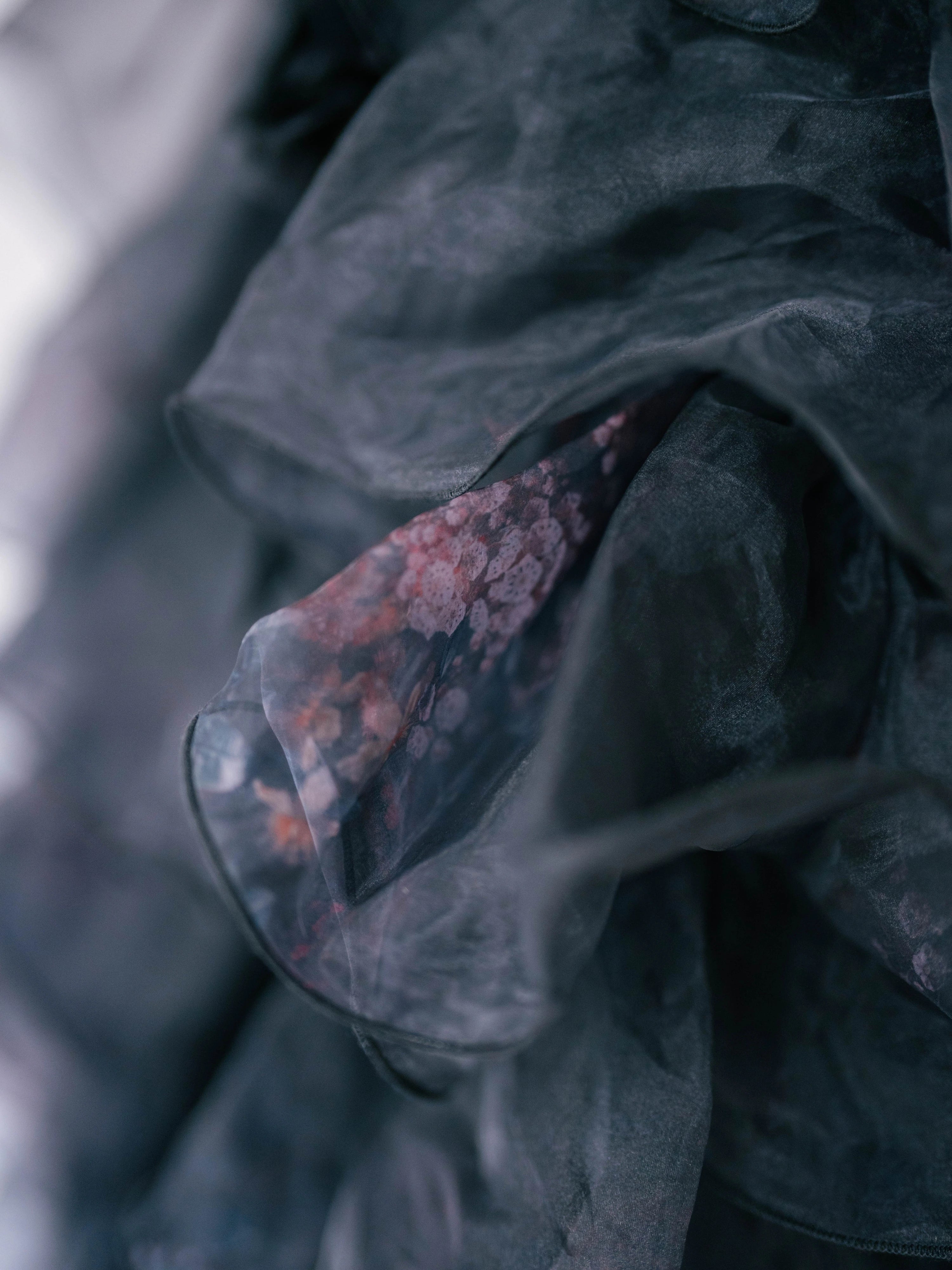 close up of the puff dresses ghostly floral print on it's poly organza fabric.