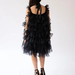 Black ruffled poly organza poofy cocktail dress with straps and tiered organza layers.