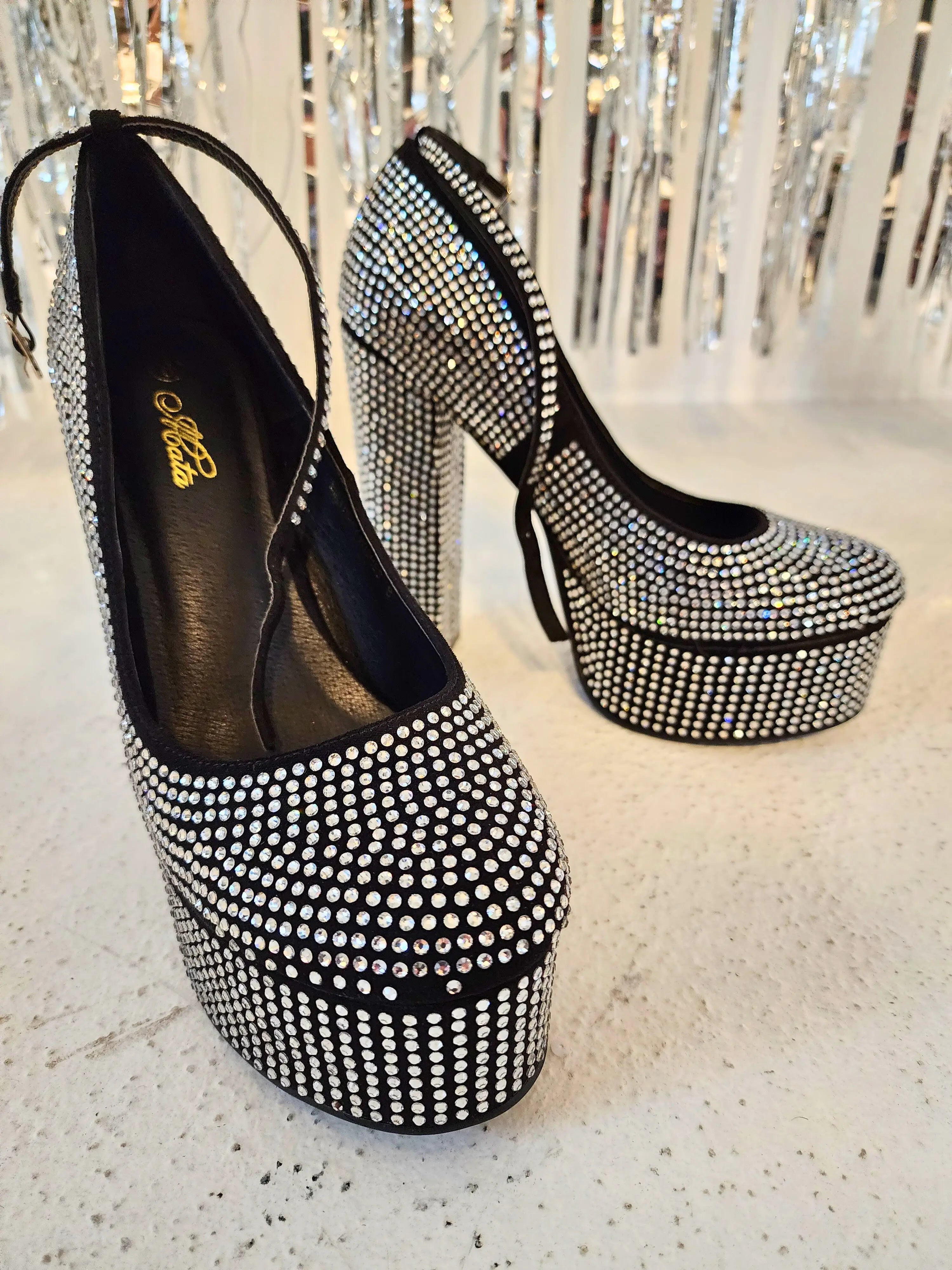 Black platform glitter heels with silver rhinestones for a stunning evening gown look.