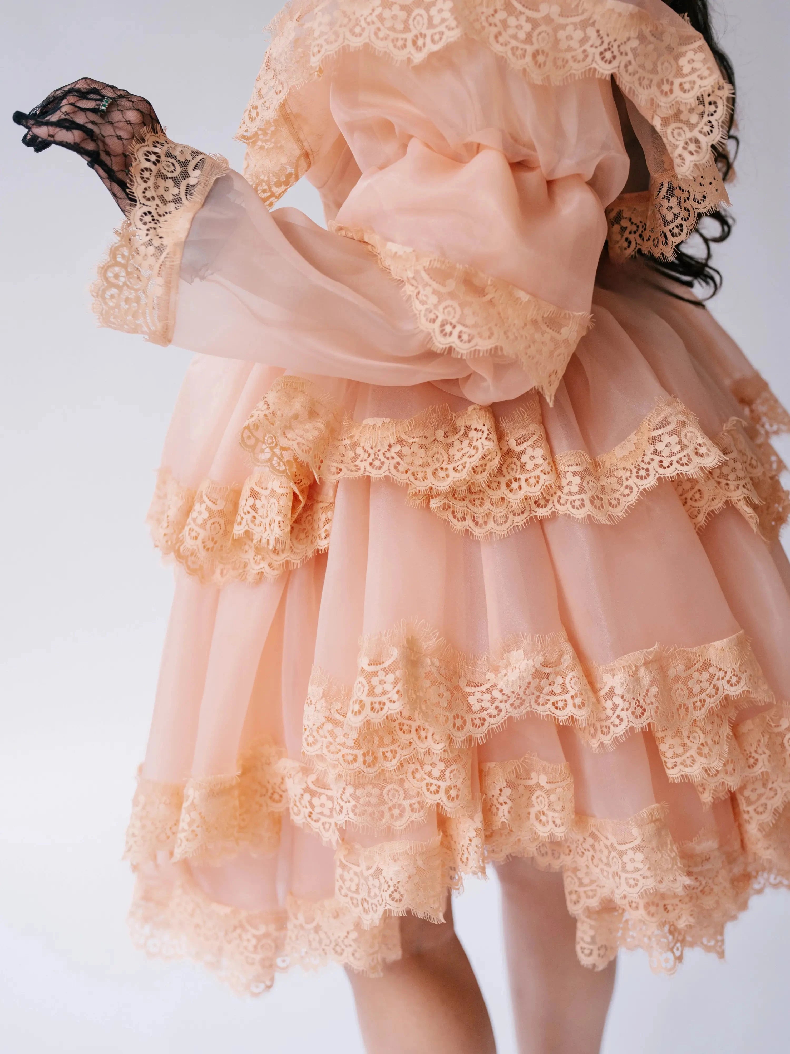 Close-up of the Midnight Symphony Mini Gown's lace-trimmed organza layers, highlighting the delicate craftsmanship and romantic texture.
