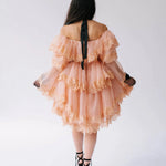 Back view of the Midnight Symphony Mini Gown showcasing tiered lace ruffles and a black ribbon halter tie in pumpkin milk organza.