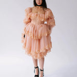 Front view of the Midnight Symphony Mini Gown in pumpkin milk organza with layered lace ruffles, styled with black platform heels.