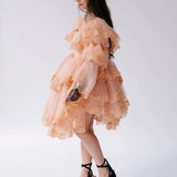 Side profile of the Midnight Symphony Mini Gown showing puff sleeves, tiered lace layers, and soft pumpkin milk organza fabric.
