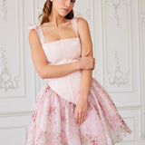 A pink floral print party dress with a fitted corset bodice and flared skirt.