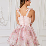 Pink corset mini dress with bow-adorned shoulder straps and a full tulle-organza skirt in the rosewater print.