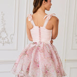 Pink corset mini dress with bow-adorned shoulder straps and a full tulle-organza skirt in the rosewater print.