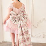 Dramatic floral bow sash belt trailing to the floor.