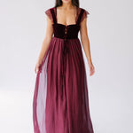 A Scarlet red floor length gown, with lace trim straps and velvet corset bodice. 