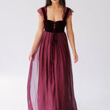 A Scarlet red floor length gown, with lace trim straps and velvet corset bodice. 