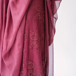 Scarlet rose-colored chiffon fabric with delicate floral embroidery layer draping underneath in soft folds.