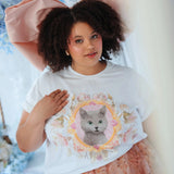 Oversized The Princess Kitten Tee worn with a large pink bow and floral skirt, showcasing a regal kitten graphic on soft cotton fabric.