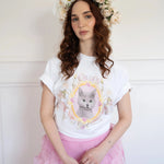 The Princess Kitten Tee worn with a pink ruffled skirt and floral crown, showcasing the regal kitten design in a soft, feminine outfit.