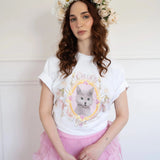 The Princess Kitten Tee worn with a pink ruffled skirt and floral crown, showcasing the regal kitten design in a soft, feminine outfit.
