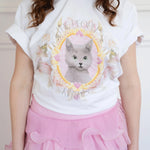 Front view of The Princess Kitten Tee paired with a pink layered skirt, emphasizing the dreamy feline artwork and soft cotton texture.
