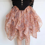 Close-up of The Twilight Bloom Bustle Skirt highlighting its cascading floral organza layers and romantic silhouette.