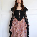 Model wearing The Twilight Bloom Bustle Skirt with a black lace-up corset top, showcasing the layered floral organza design.